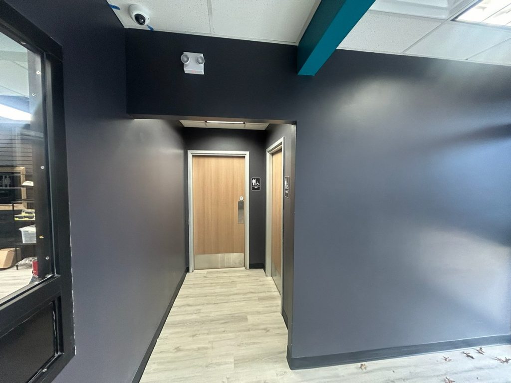 Corridor to the restrooms with charcoal walls