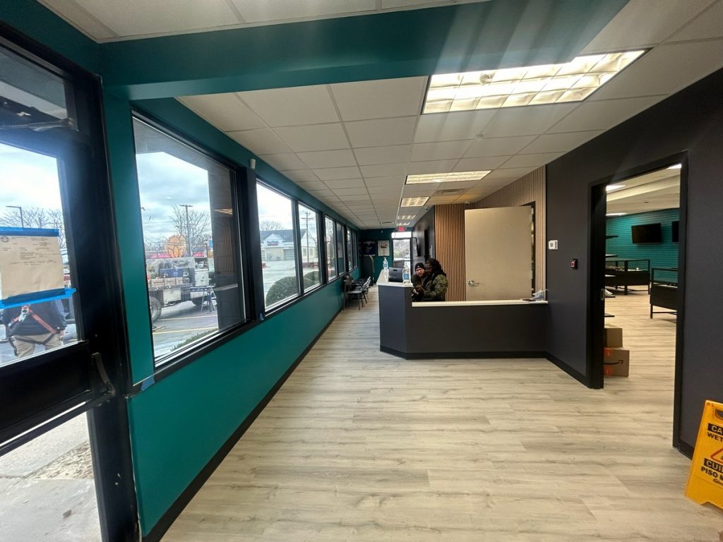 Entry vestibule with reception desk and teal accent wall