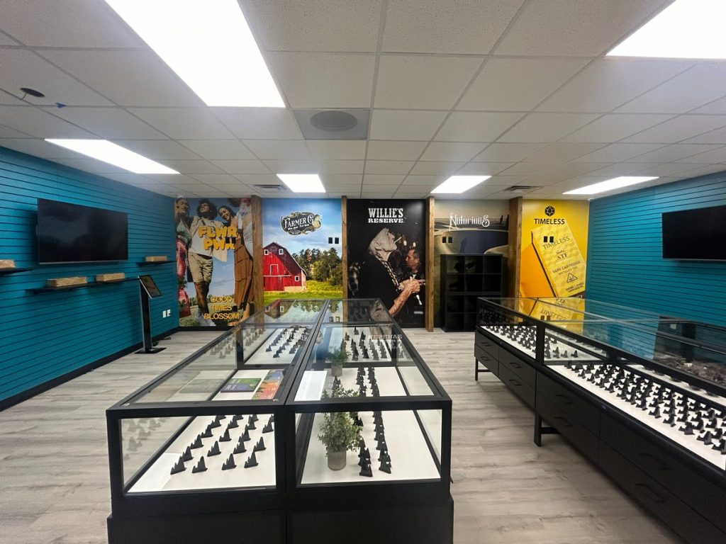 Sales floor with glass display cases and brand murals