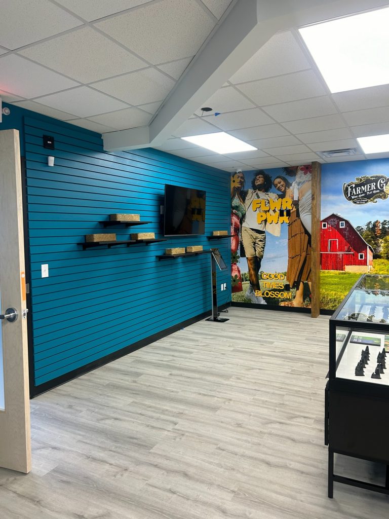 Teal slatwall with floating shelves and wall display