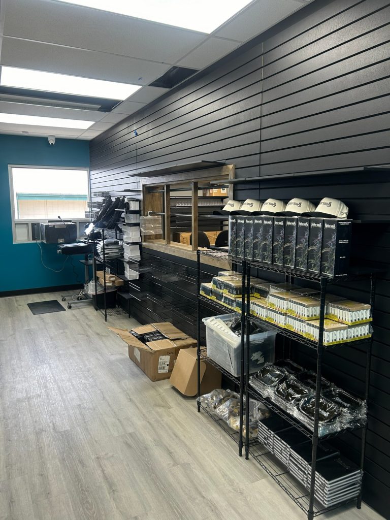 Back stock area with black slatwall and wire shelving