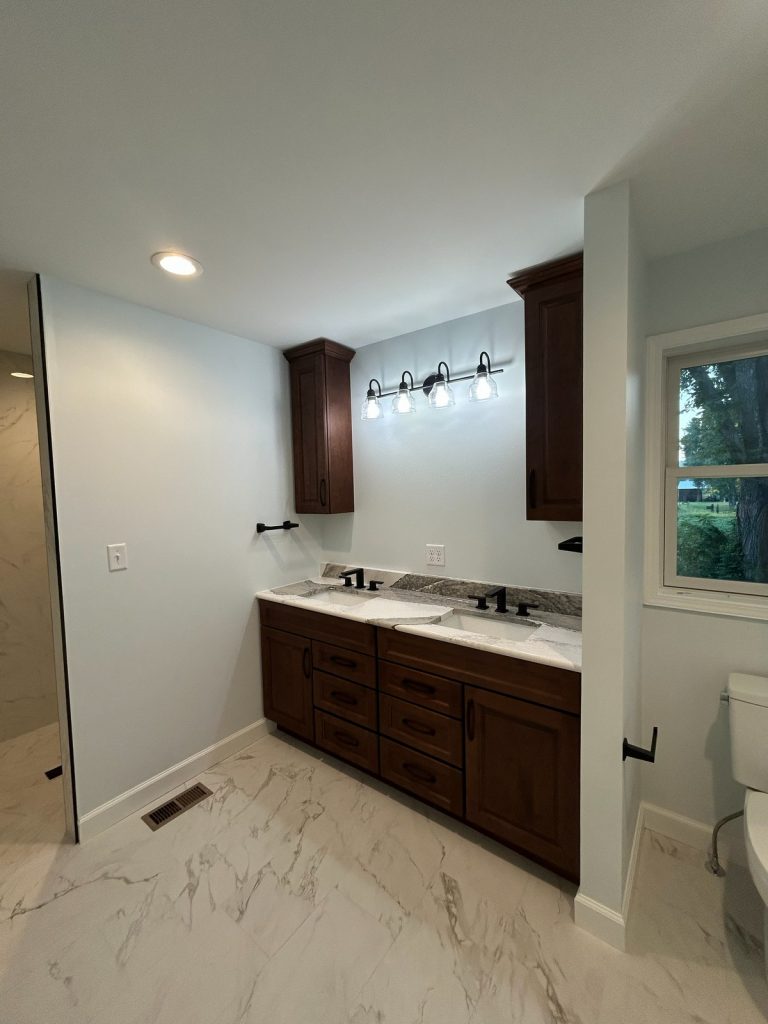 Bathroom with double vanity and marble-look tile floor