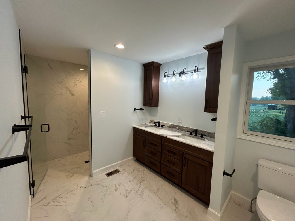 Bathroom with walk-in shower and dark wood vanity