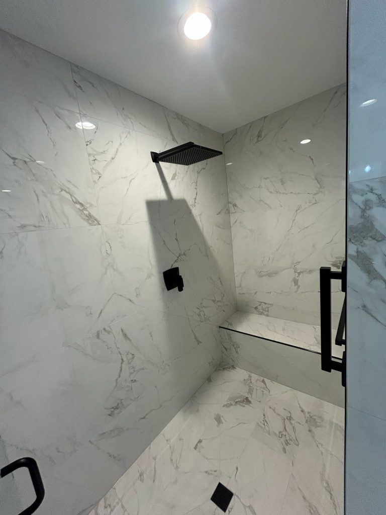 Tiled shower with rainfall head and built-in bench