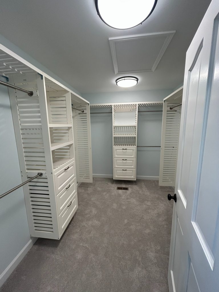 Walk-in closet with hanging rails and drawer towers