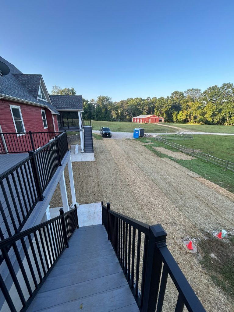 Deck stairs looking out to the barn and pasture