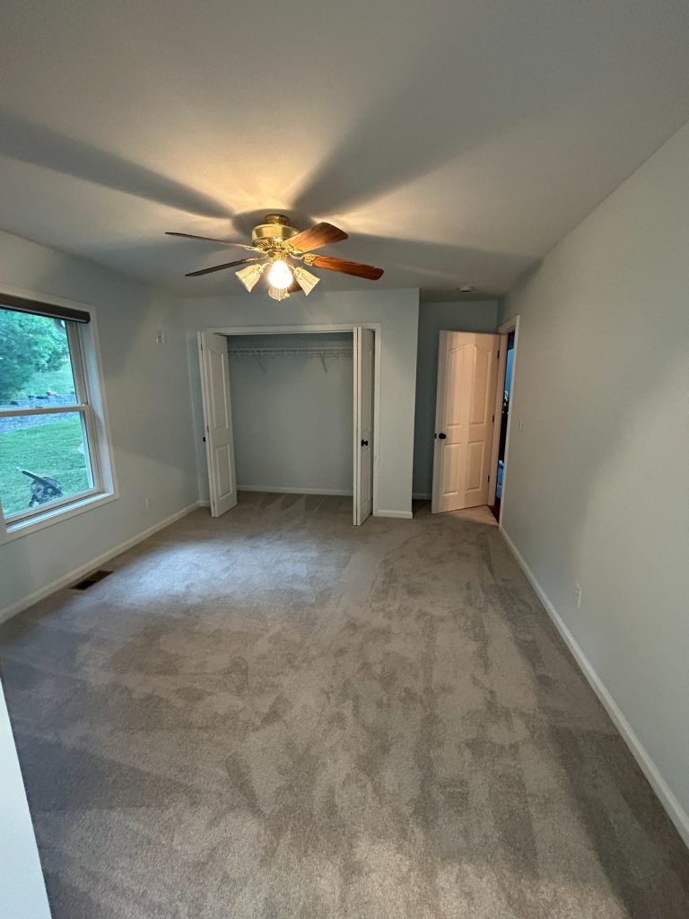 Bedroom with double closet and new carpet