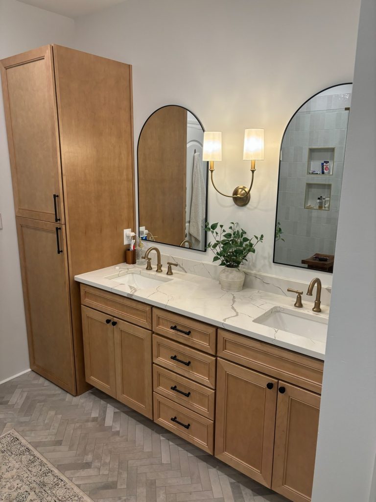 Double vanity beside a full-height linen cabinet