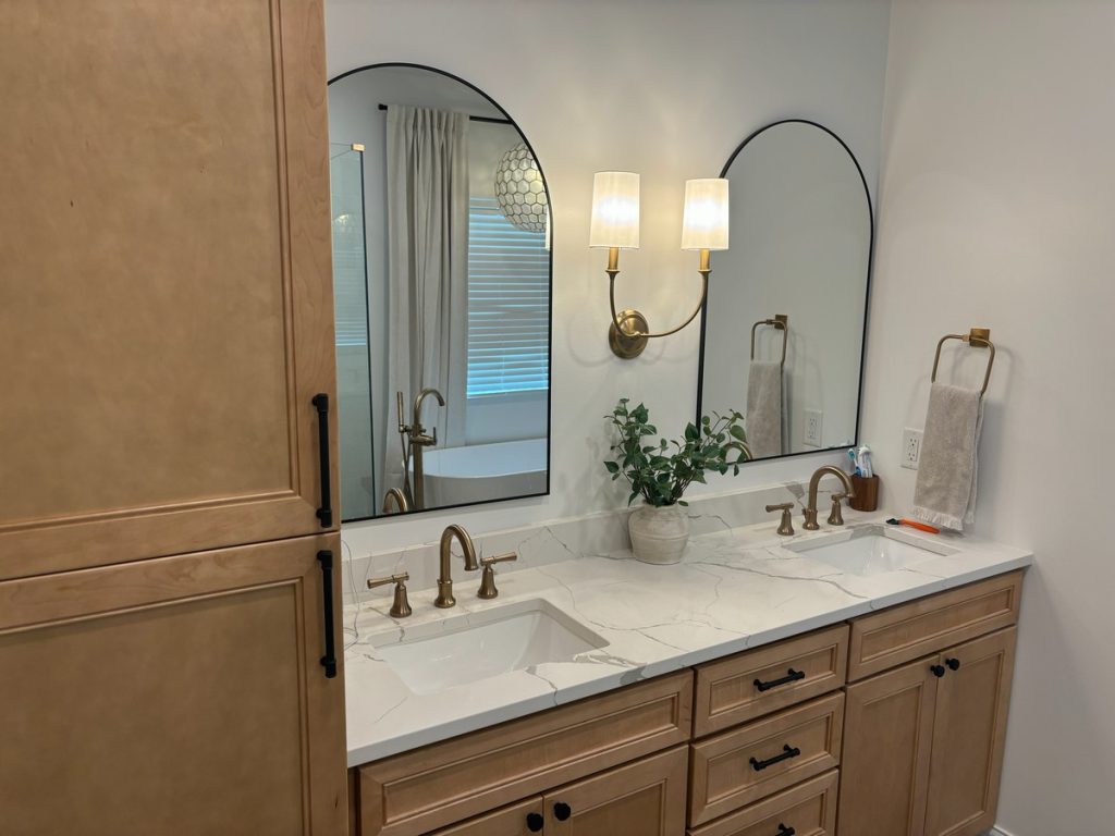Quartz vanity top with the tub reflected in the mirror
