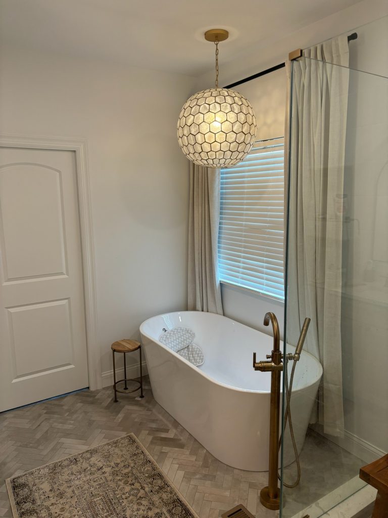 Freestanding tub below a capiz shell pendant