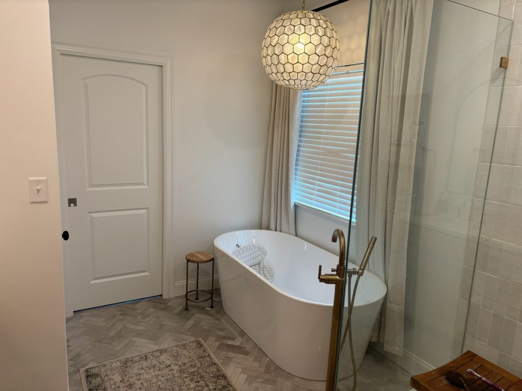 Freestanding tub beside the glass shower enclosure