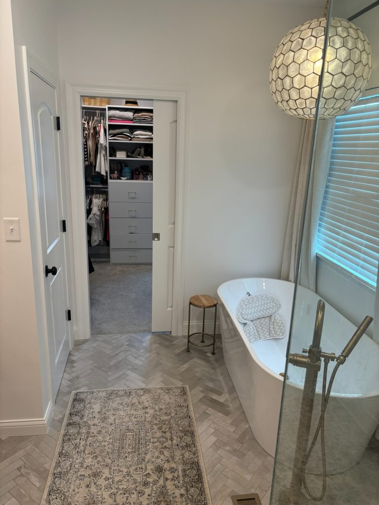 Closet doorway beside the freestanding tub