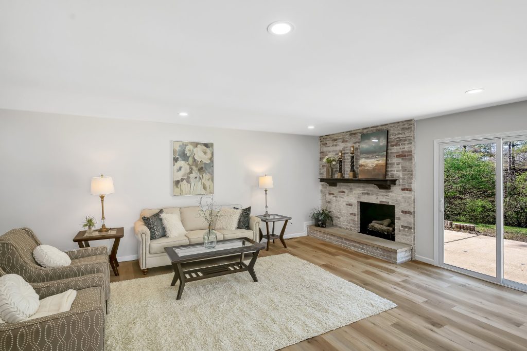 Living room with stone fireplace and cream sofa