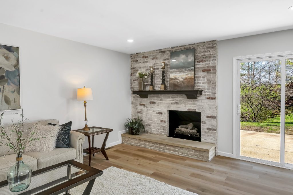Living room with stone fireplace and picture window