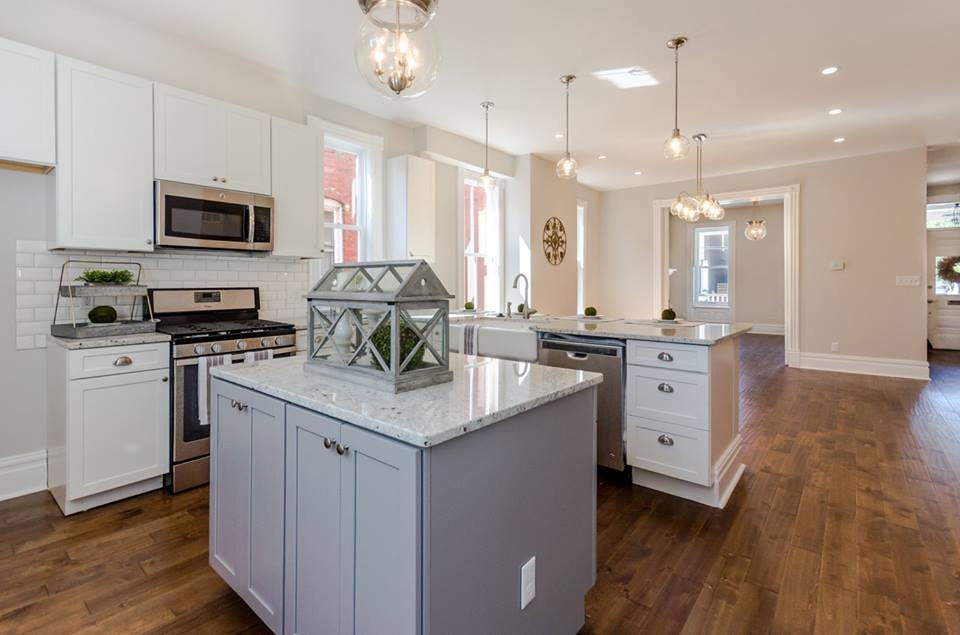 Open kitchen with two islands, stainless range and hardwood floors