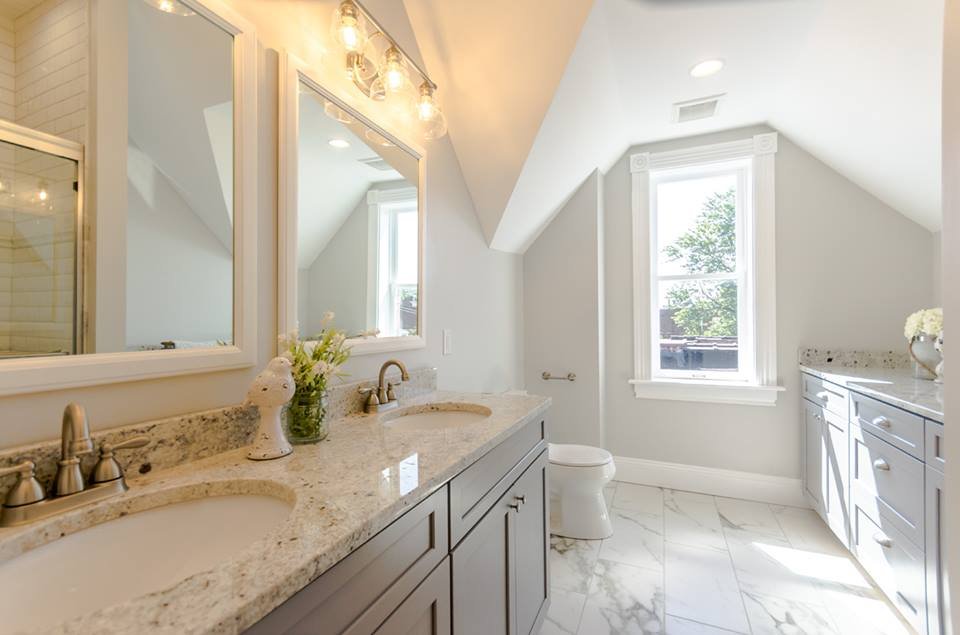 Upstairs bathroom with double vanity and marble tile floor