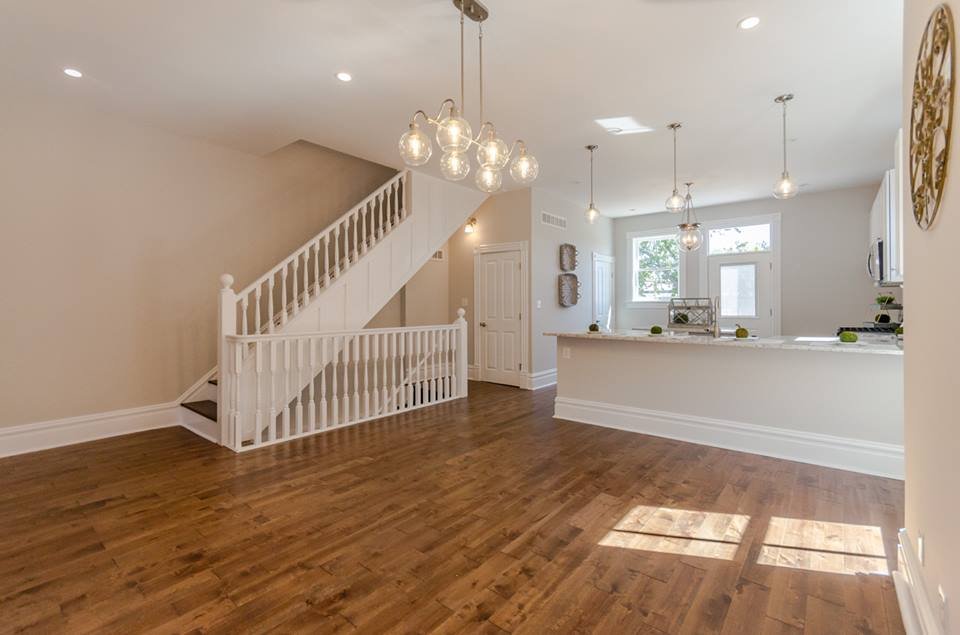 Entry room with white balustrade staircase and hardwood floors