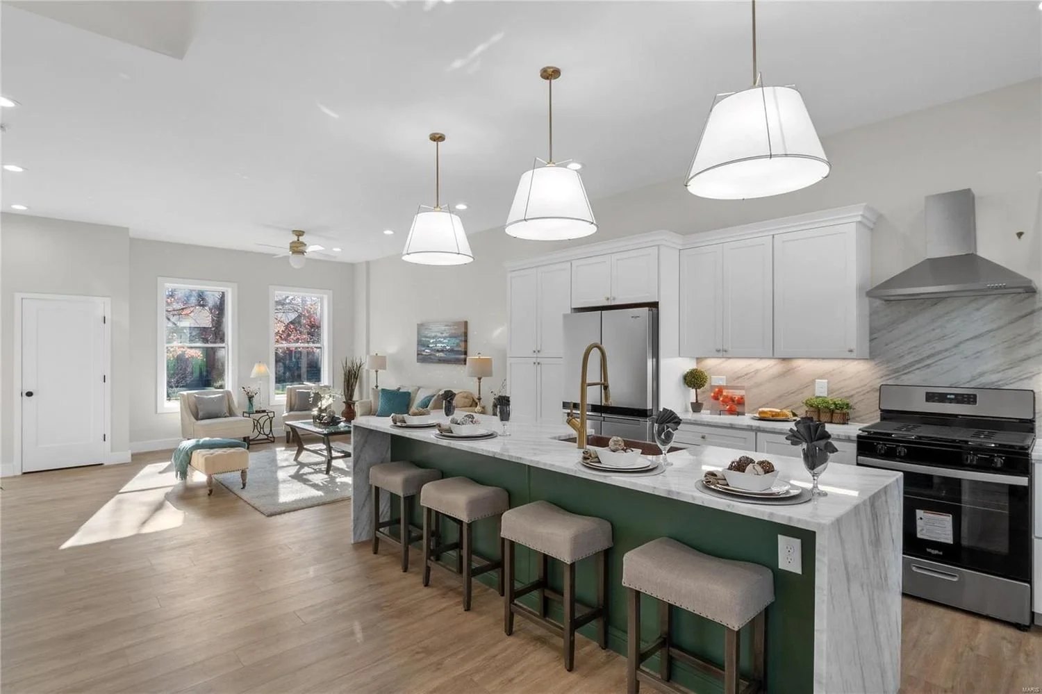 Renovated kitchen with a marble island and bar seating