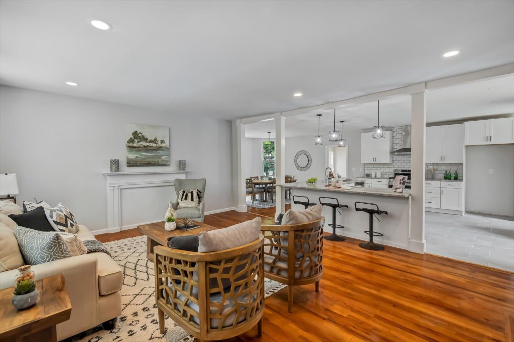 Living room with hardwood floors opening onto the kitchen
