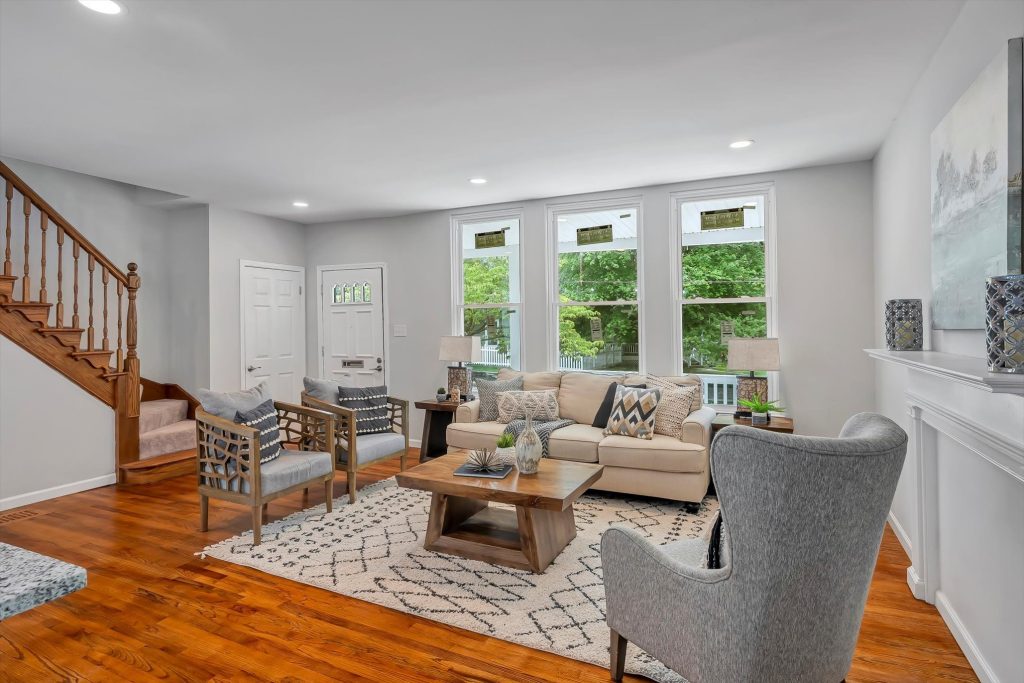 Living room with staircase, bay windows and wainscot panelling