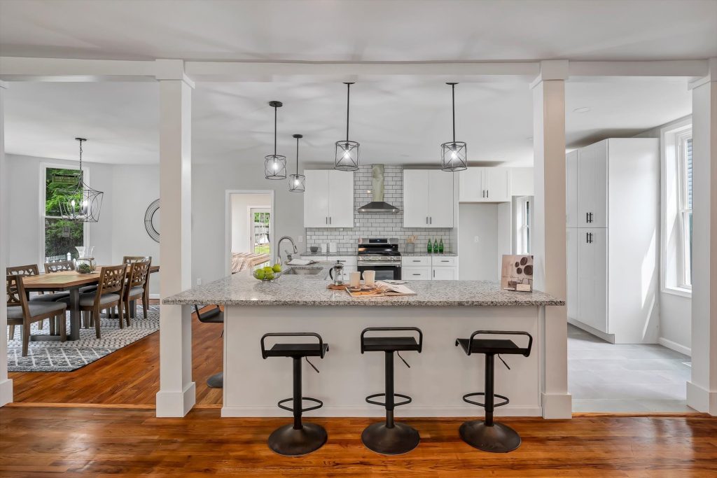 Kitchen breakfast bar with three stools and pendant lights
