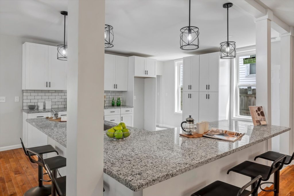 Kitchen island with granite countertop and stools