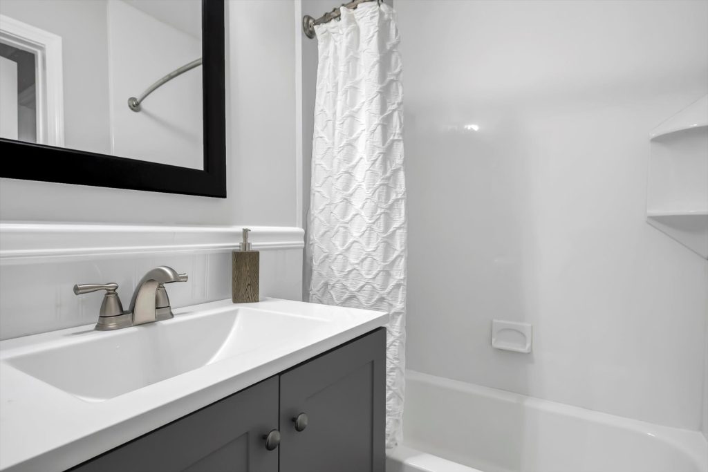 Bathroom vanity beside the shower and tub