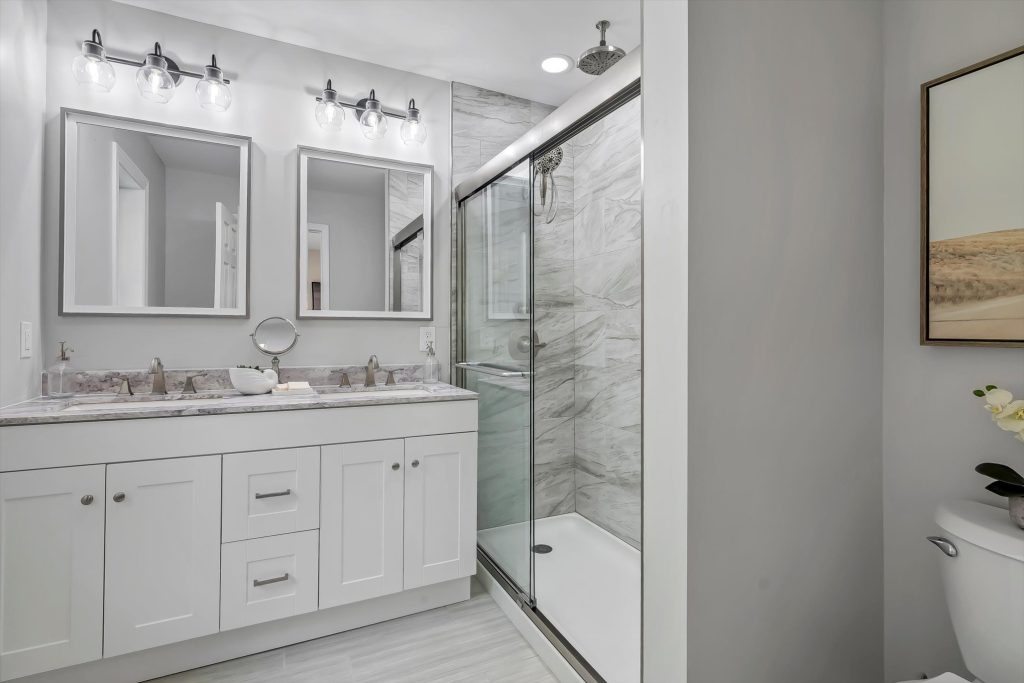 Bathroom with double vanity and glass shower enclosure