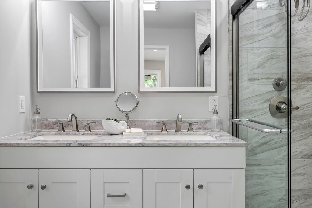Bathroom with double vanity, marble top and glass shower