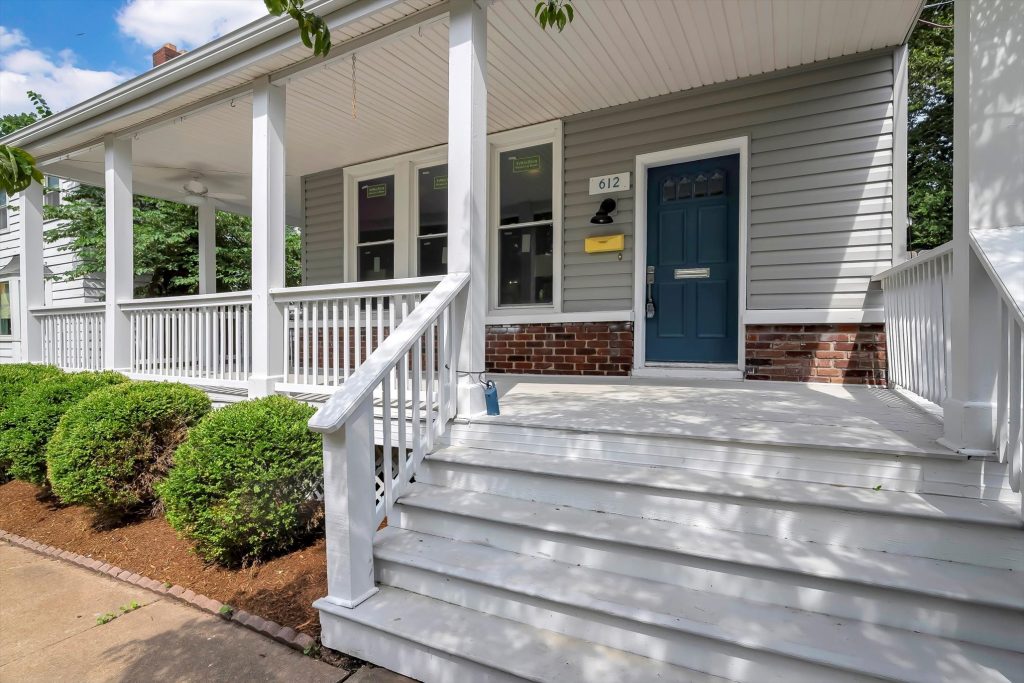 Front steps and covered porch with white railings
