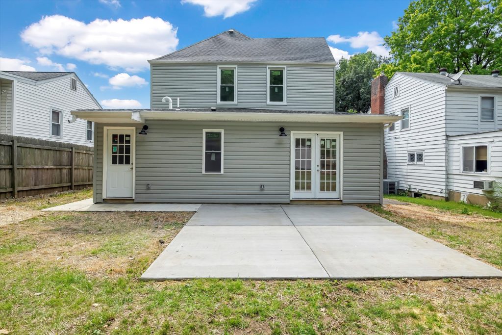 Rear elevation with French doors and new concrete patio