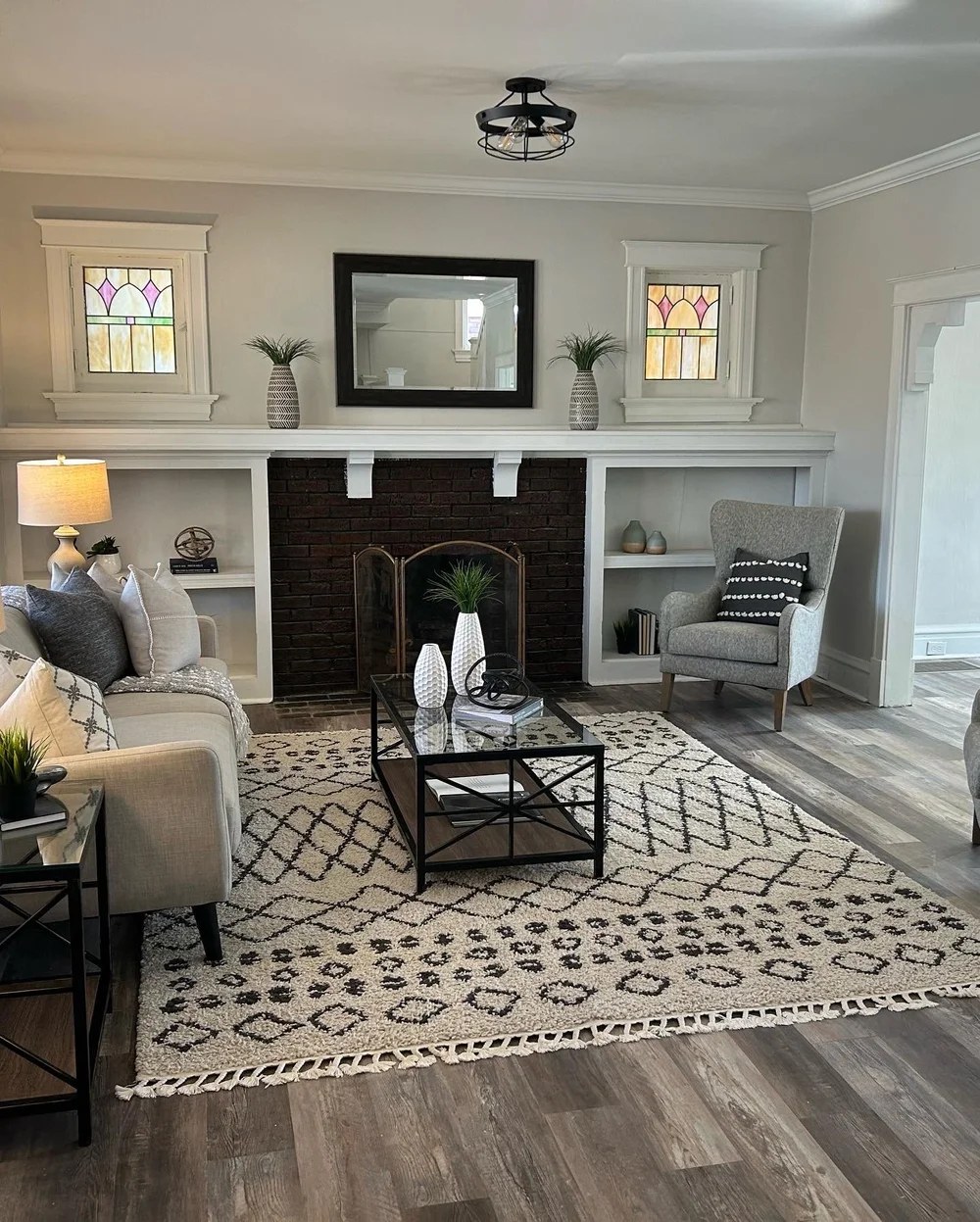 Living room fireplace with styled shelving and seating