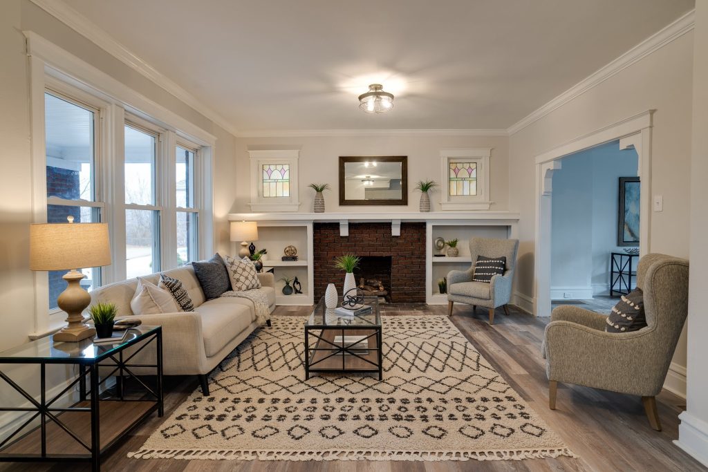 Living room with brick fireplace, built-in shelves and crown molding