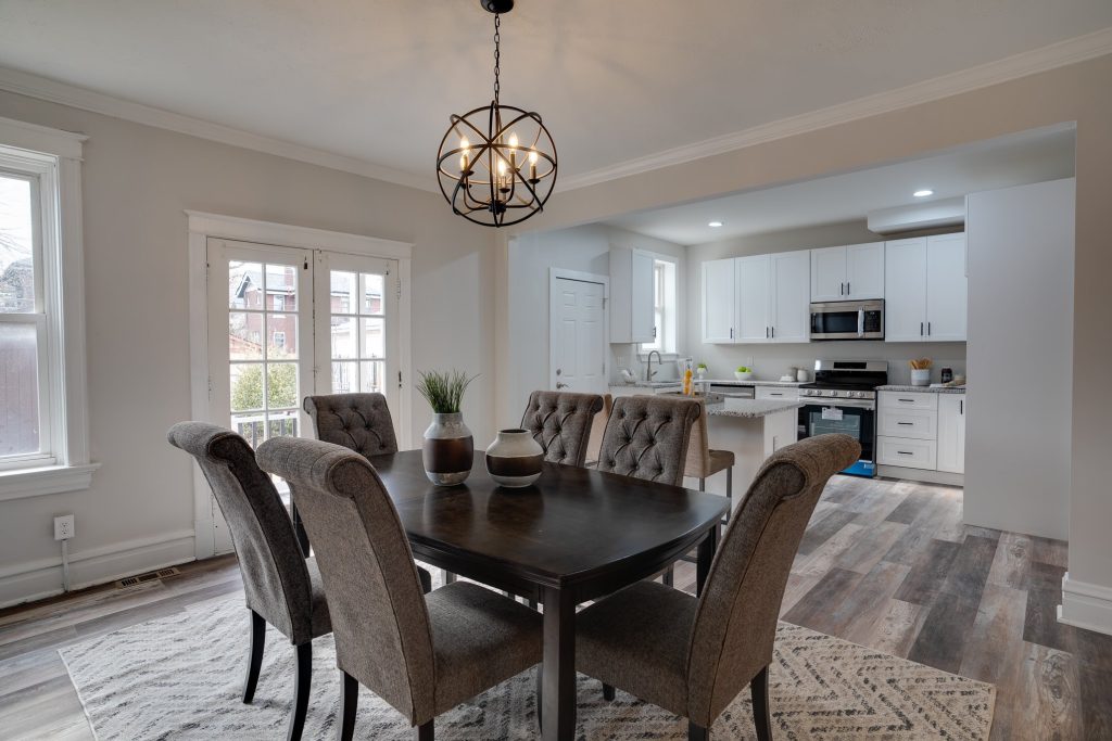 Dining room with upholstered chairs open to the kitchen