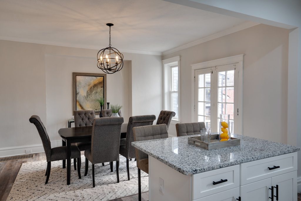 Dining room with orb chandelier beside the kitchen island