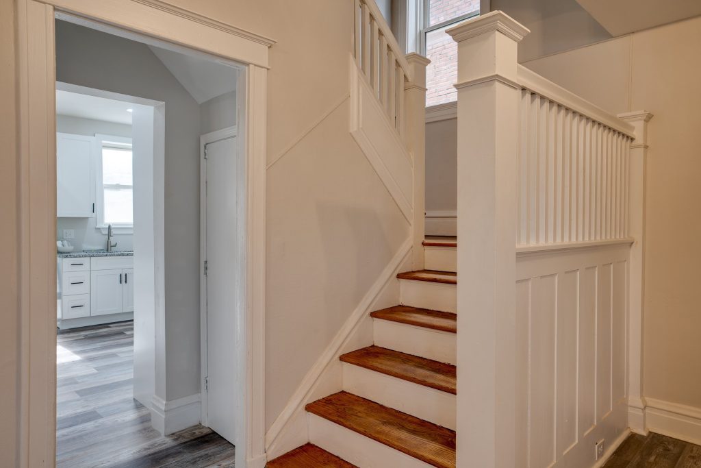 Staircase with wood treads and white balustrade