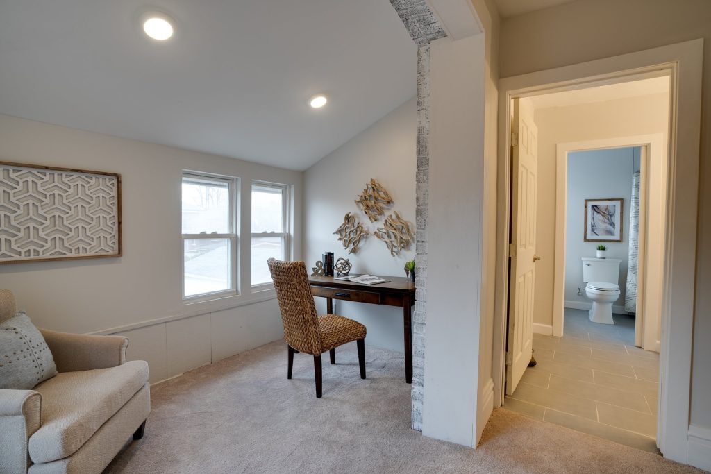 Sitting area with desk and doorway through to a bathroom
