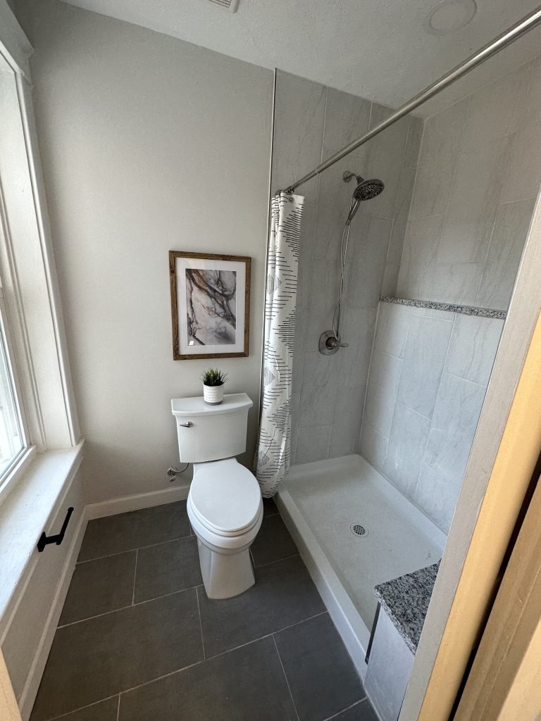 Bathroom with walk-in shower and tiled floor