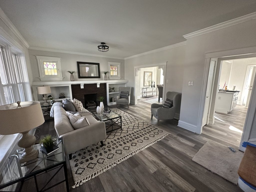 Living room with white fireplace and stained glass windows