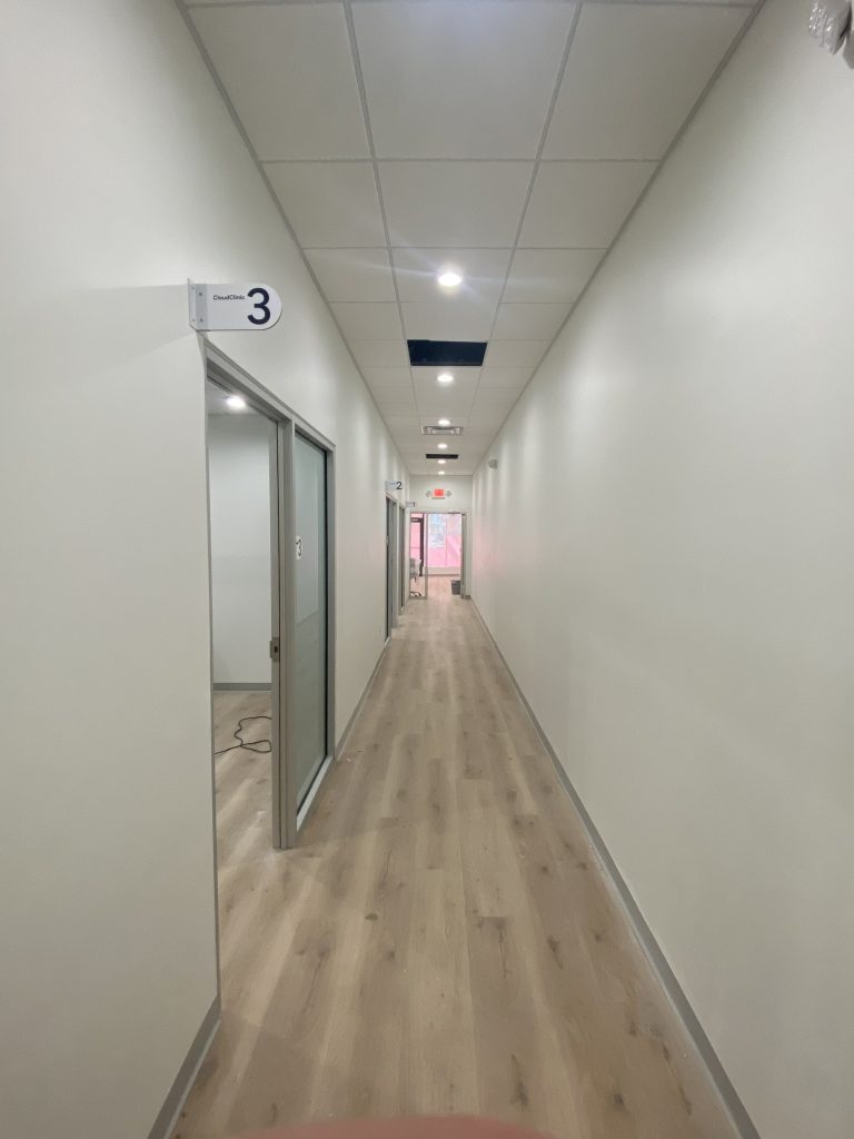 Clinic corridor with numbered consulting room doors