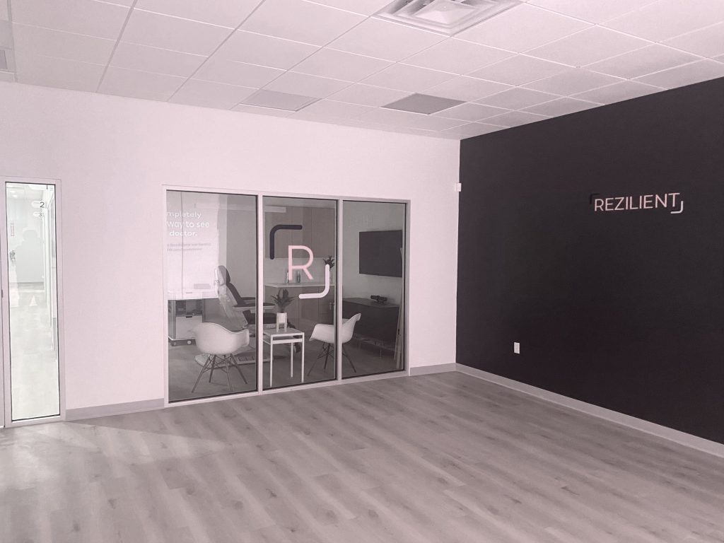Clinic reception area with dark accent wall and glass partition