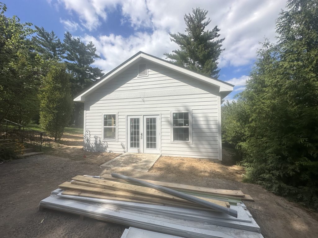 New white clapboard workshop with gable roof