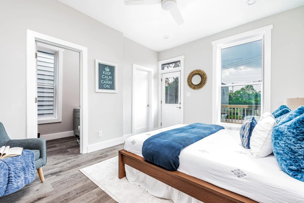 Bedroom with navy bedding and armchair