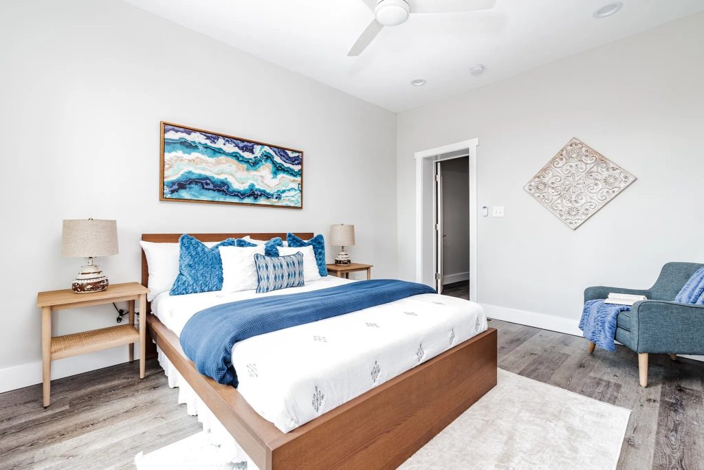Bedroom with vaulted ceiling and abstract artwork