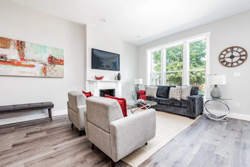 Living room with white fireplace and wall mounted television