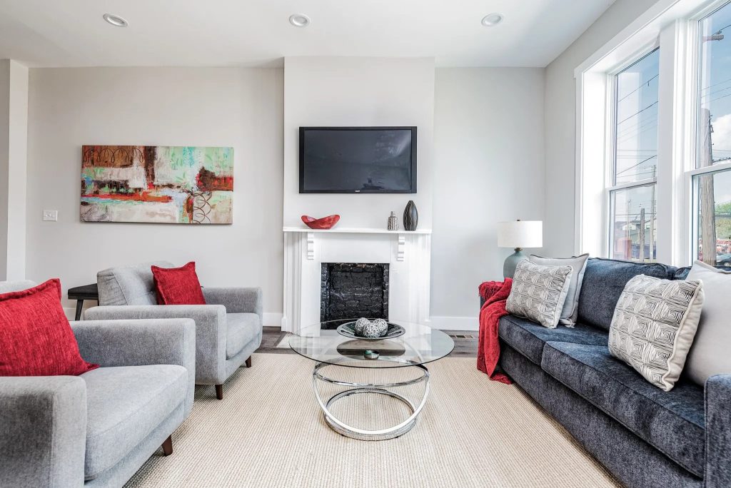 Living room with fireplace, sofa and armchairs
