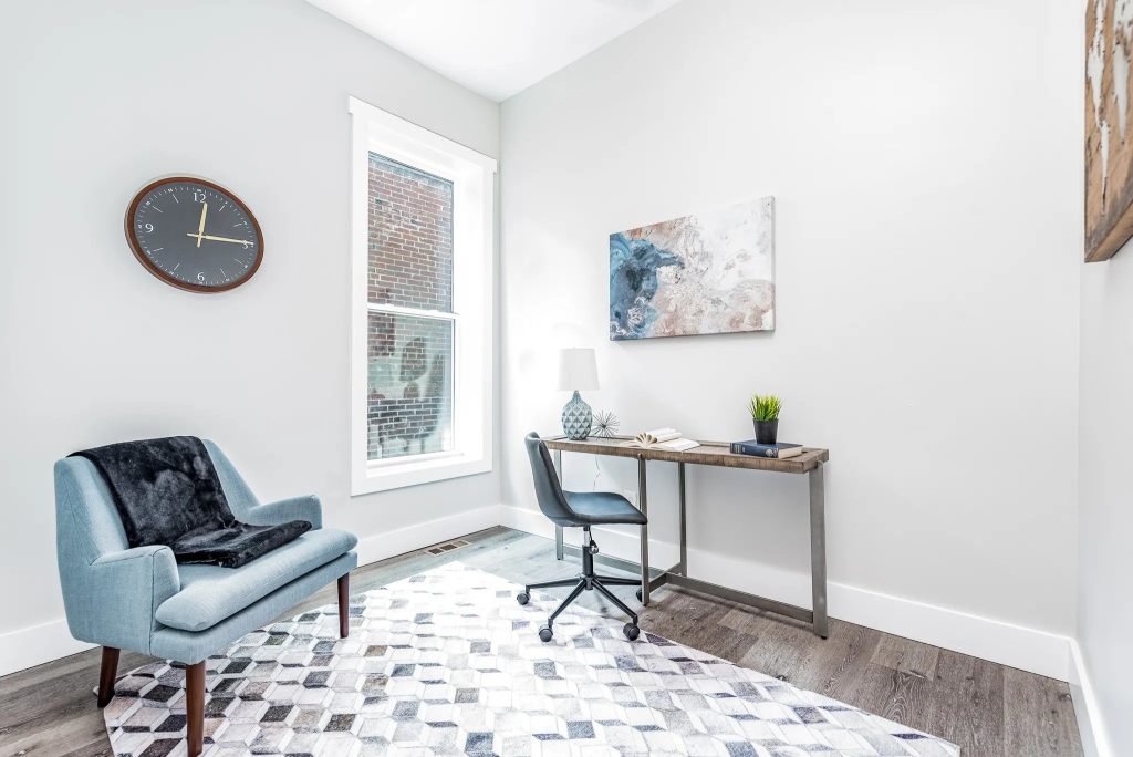 Study with armchair, desk and geometric rug