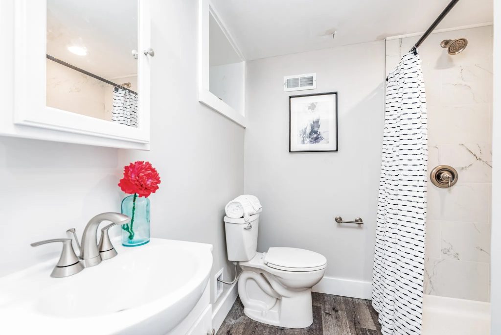 Bathroom with pedestal basin and tiled shower