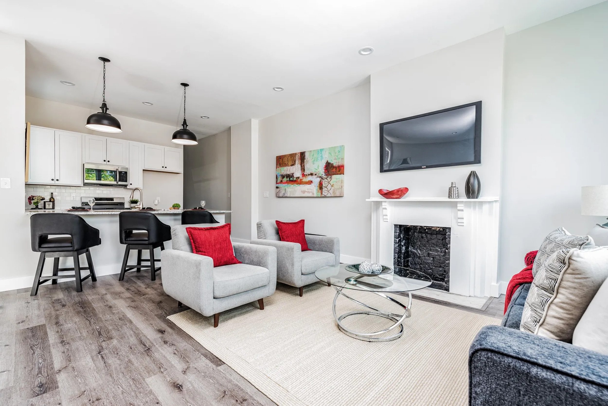 Kitchen and living room with fireplace and breakfast stools
