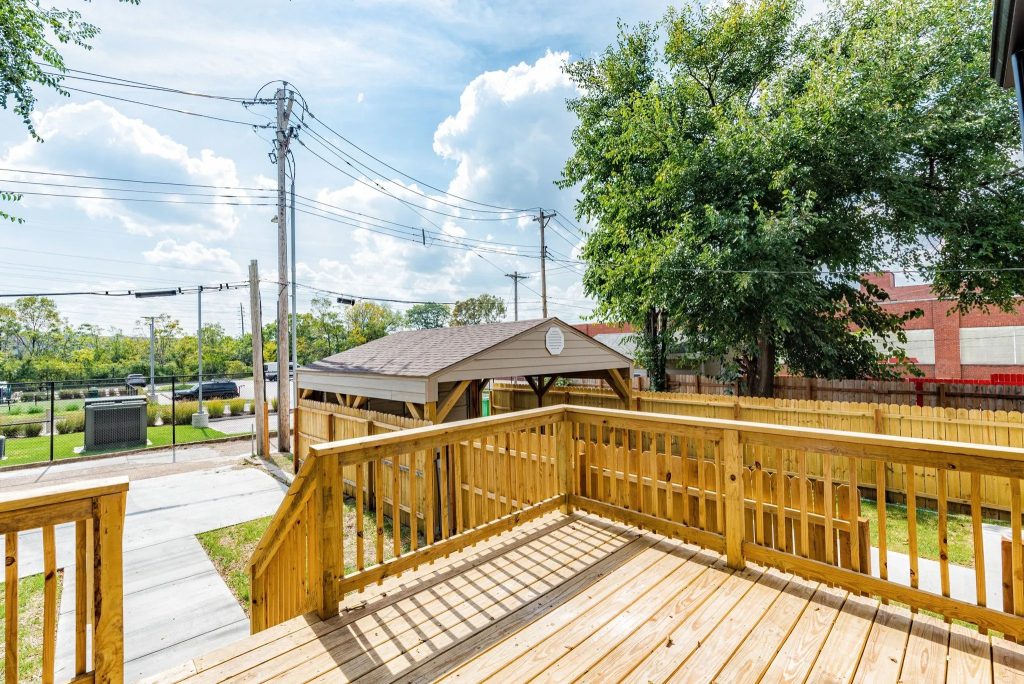 Rear deck with wood railings overlooking the yard